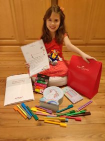 Luna T., Gewinnerin der Altersklasse 6 bis 7 Jahre, freut sich über ihr Kreativpaket.